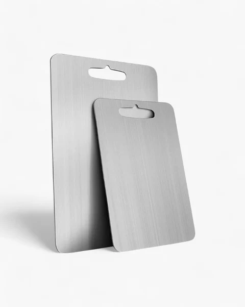 Two silver cutting boards with rounded corners and integrated handles