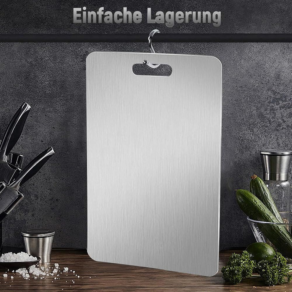 A metal cutting board hanging from a kitchen rail
